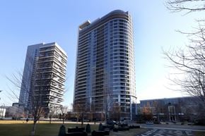 Toronto apartment for rent - Two tall buildings with a clear blue sky in the background.