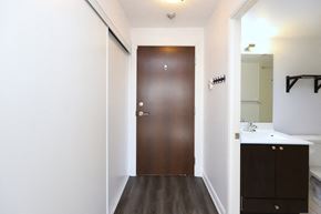 Toronto apartment for rent - A brown door is in a white hallway.