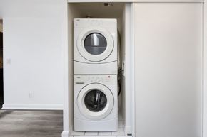Toronto apartment for rent - Two white front loading washing machines in a laundry room.