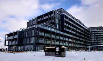 Burlington apartment for rent - A large black building with a sign that reads "ADI" in front of it.