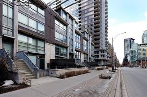 Toronto apartment for rent - A long building with a lot of windows is on the left and a shorter building with a lot of windows is on the right.