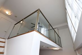 Toronto apartment for rent - A glass railing in a white room.