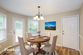 Murfreesboro house for rent - A dining room with a table set for two and a painting of a mountain scene on the wall.