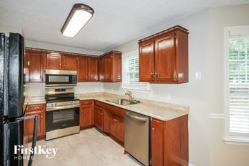 Murfreesboro house for rent - A kitchen with wooden cabinets and stainless steel appliances.