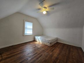Gary house for rent - A room with a bed and a window.