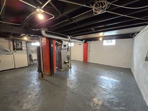 Gary house for rent - A large empty room with a red pillar and a white wall.