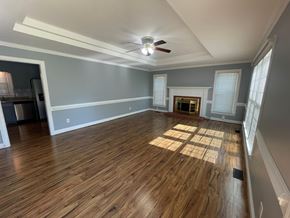Wilson house for rent - A room with wooden floors and a fireplace.