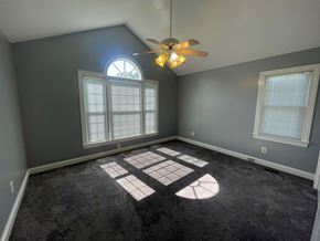 Wilson house for rent - A room with a ceiling fan and a window.