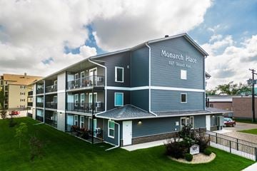 Melfort apartment for rent - A large grey building with Monarch Place written on the side.