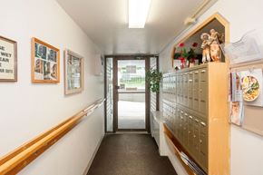 Prince Albert apartment for rent - A hallway with a sign that says "Wet Floor Wear Shoe".