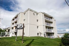 Prince Albert apartment for rent - A tall apartment building with a sign in front of it.