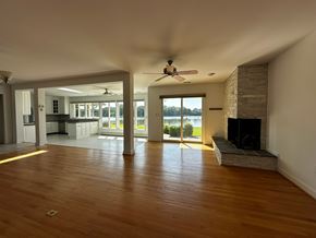 Annapolis house for rent - A spacious living room with a fireplace and sliding glass doors.