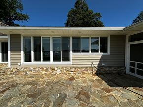Annapolis house for rent - A house with a stone patio and a grey siding exterior.