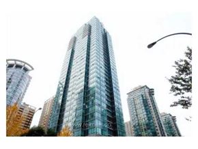 Vancouver apartment for rent - A tall glass building stands in a cityscape.
