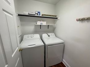 Wilson house for rent - A small laundry room with a washer and dryer.