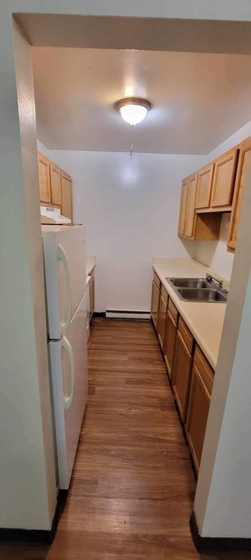 Rayland apartment for rent - A kitchen with wooden cabinets and a white refrigerator.