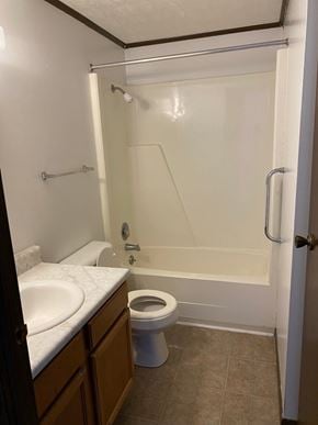 Bridgeport apartment for rent - A white toilet is in a bathroom with a walk-in shower.