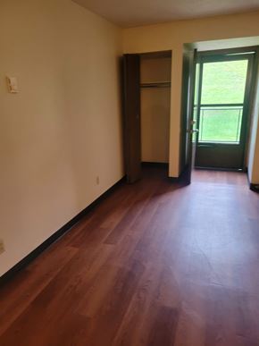 Grafton apartment for rent - A room with a wooden floor and a door leading outside.