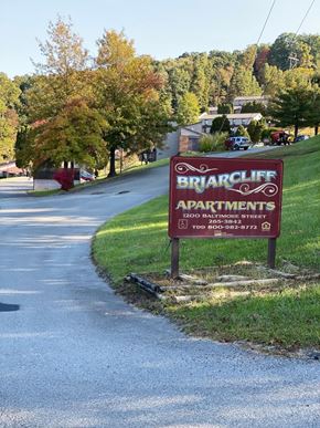 Grafton apartment for rent - A sign for Briarcliff Apartments is on the grass beside a road.