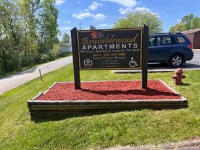 Grantsville apartment for rent - A sign for Bramblewood Apartments is displayed on a red mulch bed.