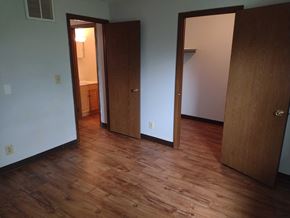 Grantsville apartment for rent - A room with wood floors and two doors.