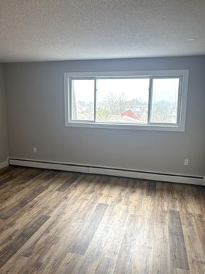 Dartmouth apartment for rent - A room with a large window and wooden flooring.