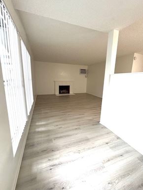 Tustin apartment for rent - A room with a fireplace and wood flooring.