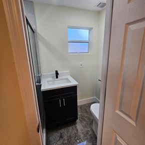Fort Lauderdale apartment for rent - A bathroom with a sink, toilet, and a window.