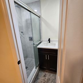Fort Lauderdale apartment for rent - A bathroom with a sink, mirror, and shower.