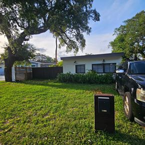 Fort Lauderdale apartment for rent - A black truck is parked next to a mailbox in a grassy area.