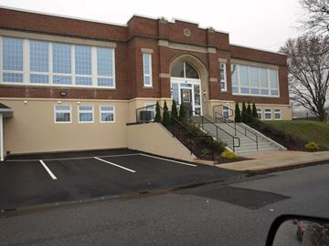 Birdsboro apartment for rent - A building with a parking lot in front.