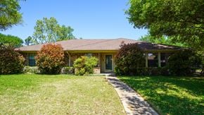 Forney house for rent - A house with a green door and a yellow house with a brown roof.