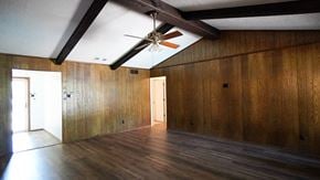 Forney house for rent - A room with wooden walls and ceiling and a ceiling fan.