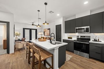 Mesa apartment for rent - A modern kitchen with a large island and wooden floors.