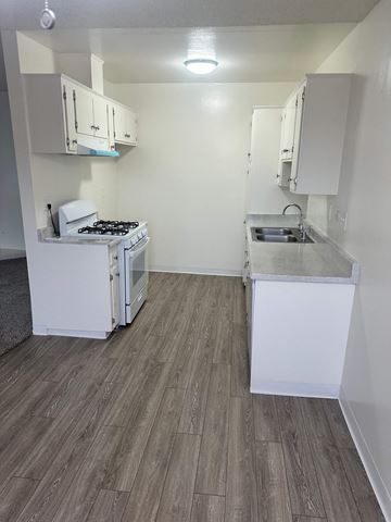 Anaheim apartment for rent - A small kitchen with a stove and sink.