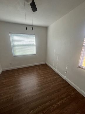 Palatka house for rent - A room with a window and a ceiling fan.