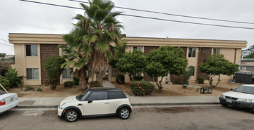 San Diego apartment for rent - A white car is parked in front of a house with a palm tree.