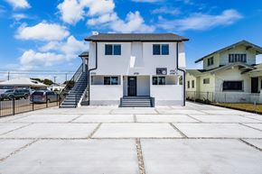 Los Angeles apartment for rent - A white two-story house with a black door and windows.