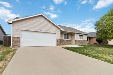 Evans house for rent - A house with a white garage door and a driveway in front.