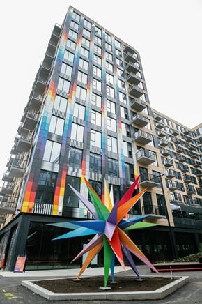 Columbus apartment for rent - A large, colorful, star-shaped sculpture is in front of a tall, colorful building.