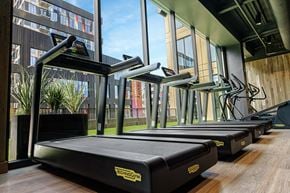 Columbus apartment for rent - A row of treadmills in a gym with a view of the outside.