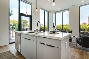 Columbus apartment for rent - A modern kitchen with white cabinets and a large island.