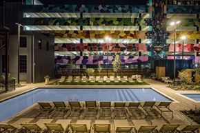 Columbus apartment for rent - A pool area with sun loungers and a building in the background.
