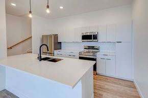 Columbus apartment for rent - A kitchen with a white countertop and a black faucet.