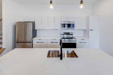 Columbus apartment for rent - A modern kitchen with a stainless steel refrigerator and a white countertop.