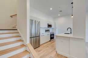 Columbus apartment for rent - A kitchen with a stainless steel refrigerator and wooden flooring.
