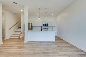 Columbus apartment for rent - A kitchen with a white counter and wooden floors.