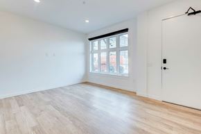 Columbus apartment for rent - A room with a white door and a window with a view of a building outside.