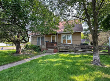 Wausau house for rent - A house with a brown roof and a wooden fence.