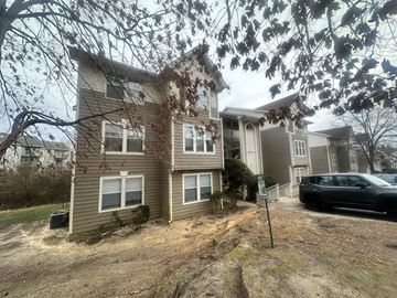 Fayetteville house for rent - A two-story house with a car parked in front.